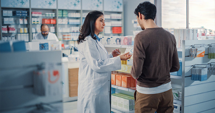 Pharmacist explaining medication to customer
